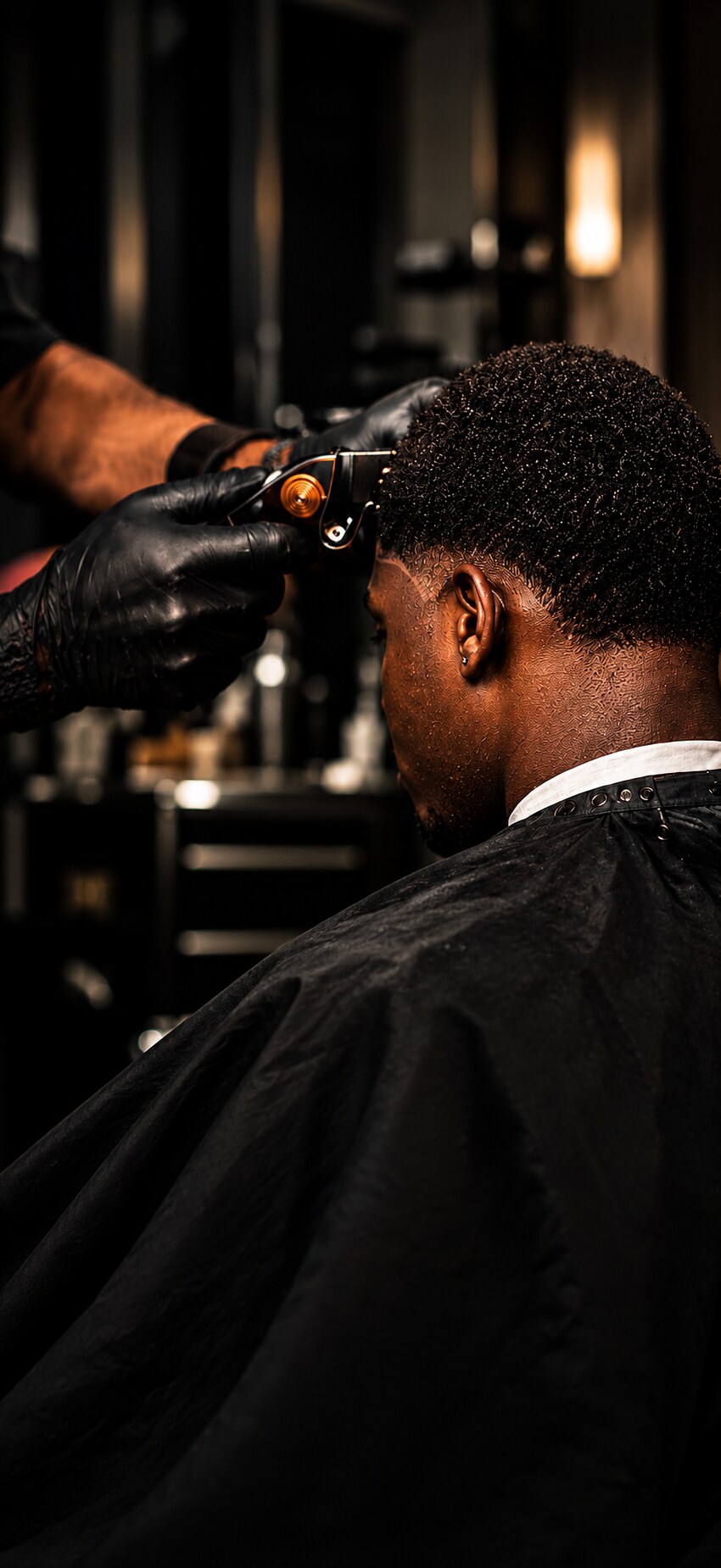 IDYAN barber cutting a client's hair with clippers